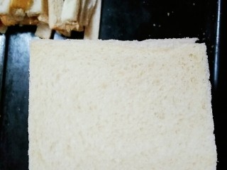 1、苹果派,把吐司片四周切掉黄色部分，注意不要切太多了，留下白色部分备用，切掉的黄色部分就把它吃了????