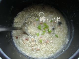 6、皮蛋瘦肉粥,高压锅压好自然放气后开盖。加入炒好的肉丁、熟芝麻、葱花拌匀，加盐调味即可。