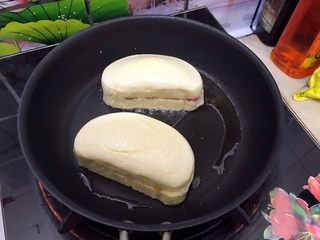 15、美好早餐开启美丽心情の黄金果酱馒头西多士+美式炒鸡蛋,放入馒头片,小火慢煎
