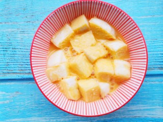 6、孜然火腿馒头丁,将馒头丁放入蛋液中洗个澡。