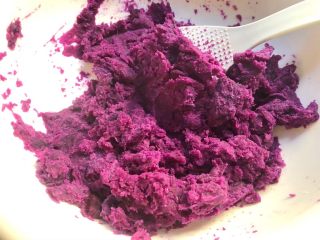 6、紫薯糯米丸子,倒入大一点的碗里，用勺子压碎。