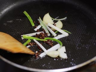 9、香辣干锅土豆片,下蒜片、葱段炒香。