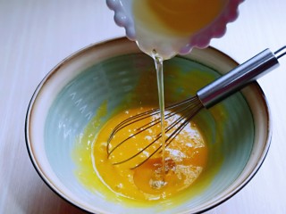 4、红丝绒草莓奶油蛋糕卷～下午茶必备甜品,先做蛋黄糊，蛋黄用手动打蛋器打散，加入玉米油，使油和蛋液完全融合再一起，(色拉油也可以，但是一定要无味的)不建议使用黄油或橄榄油。