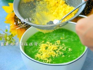 9、菠菜蛋黄十倍粥,盛到碗里。将蛋黄用滤网压成泥。8个月以上的宝宝就可以吃一整个蛋黄了。