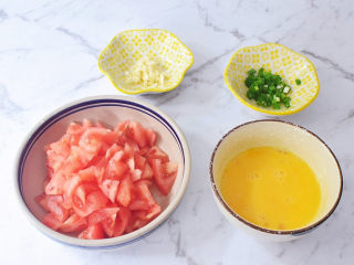 2、西红柿鸡蛋面,西红柿洗净底部切十字，放入开水中焯烫，烫至皮翘取出去皮，然后切成小块备用，鸡蛋打散，蒜切末，葱切葱花