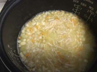 11、电饭煲+蘑菇鸡丝暖胃粥,加入鸡丝,并用筷子搅散鸡丝。