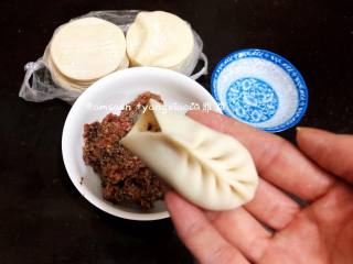 7、三鲜柳叶饺子,用拇指和食指捏一个褶儿,然后顺着食指方向捏褶,根据饺子皮的大小依次捏好好褶子,褶子尽量捏小点,我捏的大概在8个褶子上下,捏完稍整形整成弯弯的柳叶形状,形状也可按个人喜好来做