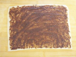 7、老北京麻酱糖火烧,操作板表面刷少许油，就是传统的油案，将饧好的面团擀成薄片，分点抹酱，涂匀