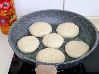 16、皮薄馅大～发面梅干菜肉饼,起锅，加入花生油，放入饼胚，盖上盖子小火慢煎。(全程小火)