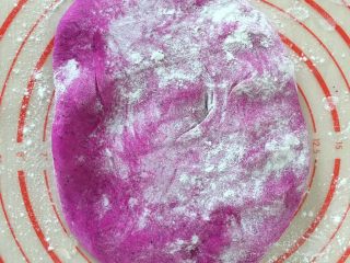 9、火龙果馒头,取出来按扁排气,加适量面粉防粘。