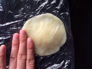 16、黄桃糯米糍,将手将圆团按压成“边缘薄、中间厚”的面皮。