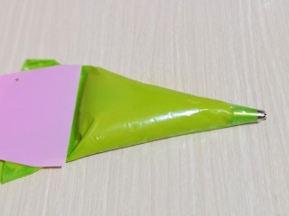 12、零失败~奶油泡芙 外酥内软吃出幸福甜蜜,将面糊装入裱花袋,(先装入裱花嘴,再装面糊哈)用刮板将面糊往前推,如图。