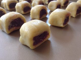 10、紫薯一口酥,放在不粘烤盘上，表面涂蛋液，沾上熟芝麻