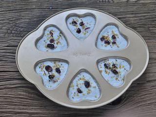 7、桂花蔓越莓松糕,再铺过筛好的粉至模具满，表面撒几颗蔓越莓干和一些干桂花。