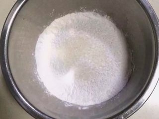 5、红枣核桃糯米糕,把糯米粉和细砂糖加入到大盆内。