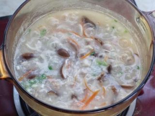 8、香菇滑鸡粥,待米粒开花呈黏稠状撒葱花，再淋入香油搅拌均匀关火即可。
