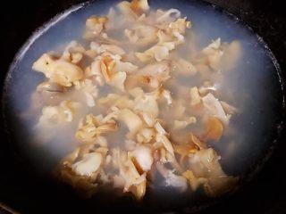 3、香葱爆海螺片,锅中烧开水下入片好的海螺肉片翻滚一下（大概4-5秒）立即捞出放入冷水中冲凉