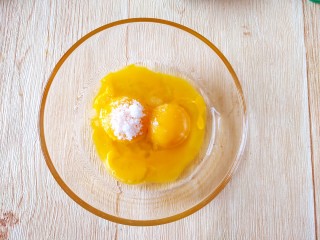 4、咖啡小蛋糕,先做蛋黄糊部分，加入玉米油，蛋黄和10克细砂糖一起搅拌至糖融化。