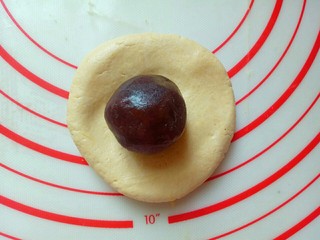 5、芝麻南瓜饼,取一块面团，用手掌心按扁，搬去豆沙馅。(面团每个约50g，豆沙馅每个约20g)