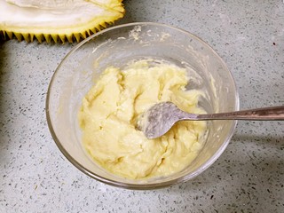 11、榴莲披萨,把榴莲肉拆下来，加入一勺炼乳，用勺子碾压搅拌成泥。