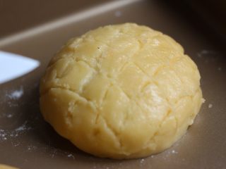 13、菠萝包,用刀轻轻地在酥皮上划出格子菠萝纹。也可以用模具印花纹比较整齐。此时烤箱预热190度。