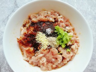 4、冬至美食  鲜肉酥饼,加入老抽、糖、蚝油、盐、白胡椒粉，鸡精和小葱叶搅拌均匀。