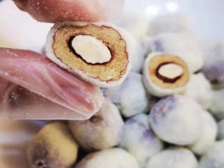 4、奶枣,加入灰枣搅匀.使每颗枣包裹上棉花糖.趁热一颗颗揪下来.团匀.裹上奶粉