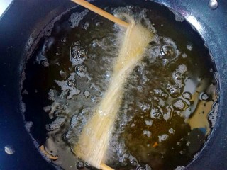 13、馓子,放入油锅中炸。筷子先不要拿掉。