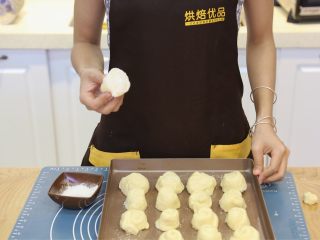 10、蜂蜜椰蓉小面包,10.将底部蘸料混合均匀。将切好的面团的底部，摸上一点清水，蘸满混合好的蘸料。