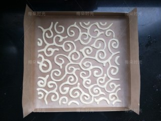 15、唐草彩绘蛋糕卷,放进烤箱，烤2分钟。烤定型。然后把底下的图纸抽出来。