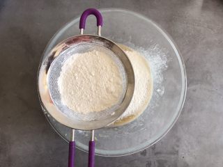 6、香蕉巧克力豆蛋糕,筛入低筋面粉和泡打粉，翻拌均匀看不见干面粉即可