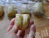 16、枣泥一口酥,拿起一块儿小面卷，收口朝上，用拇指将面卷两端往中间收