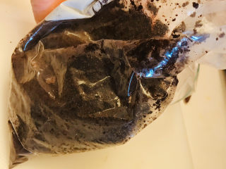 5、巧克力慕斯蛋糕,用手揉搓食品袋，让饼干碎和黄油充分混合。