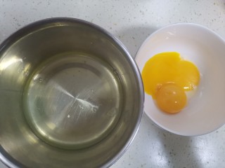 2、奶香南瓜手指饼干,准备两个干净无油无水的盆，分离蛋清和蛋黄，蛋白里不能掉入蛋黄，否则蛋白打不起来，分离好的蛋白放冰箱冷藏备用