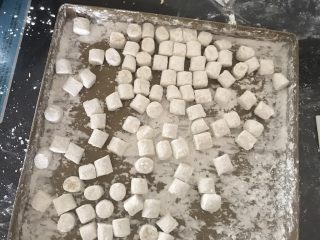 7、多彩芋圆,烤盘里面撒一些玉米淀粉，切好的芋圆放烤盘里滚一滚，这样可以防粘，用不完的可以装保鲜袋冰箱冷冻，