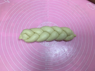 11、淡奶油辫子面包,然后将辫子翻转过来，开始编左侧，收口处同样捏紧。