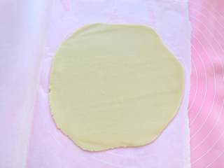 6、网红甜品+酥皮泡芙,将面团放在两张油纸中间，用擀面杖擀成厚度约为2-3mm的面片，放进冰箱冷冻约10分钟