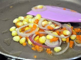 14、香肠吐司披萨,玉米、洋葱、胡萝卜小火翻炒2-3分钟。