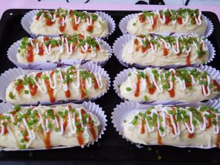 12、香葱芝士面包,依次撒上马苏里拉奶酪，挤上番茄酱，沙拉酱，撒一点香葱叶，就可以进烤箱了