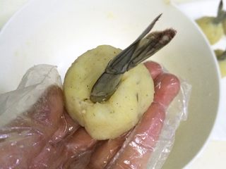 13、黄金虾球,把虾尾插入土豆虾球中，收好边，捏紧了，10个虾球全部操作完成。