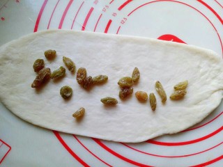 13、最爱面包＋葡萄干小面包,取一块面团，用擀面杖擀长舌状，放入洗干净的葡萄干。