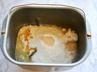 2、椰香吐司,将牛奶、鸡蛋、盐、白糖、高筋面粉、椰子粉、酵母、玉米油依次放入面包桶内