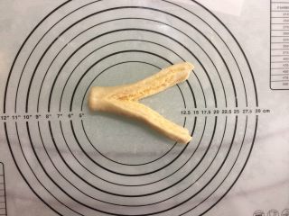 10、椰蓉面包小卷,取一卷，稍加压扁，用刀纵切开来，注意面卷一头不要切断。
