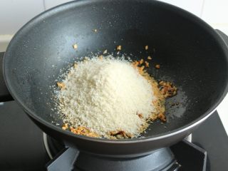 11、避风塘炒虾,倒入面包糠，要快速搅拌，面包糠会迅速吸干所有的油，变得焦脆。