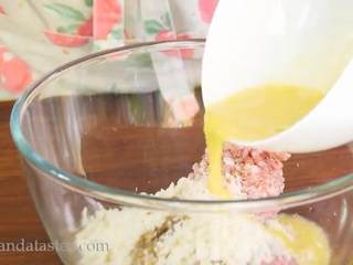 7、炸肉饼,把牛肉和猪肉放入大碗中，倒入洋葱丁、面包屑、肉豆蔻屑、伍斯特酱汁、一半蛋液，用手抓捏，撒入盐