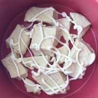 9、肉松手撕面包,把小面团铺在模具里，图里我用的是7寸的，不用正好铺满，然后先挤上蛋黄酱。撒上肉松，这里可以多放一些，然后再肉松上再挤上一层蛋黄酱。