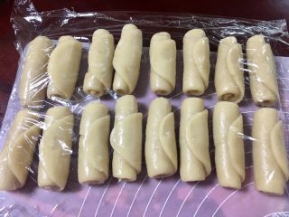 10、馅中馅蛋黄酥(肉松麻薯豆沙蛋黄),擀长后从一头卷起,保鲜膜盖好,醒十五分钟。