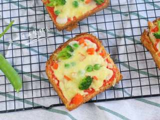 8、吐司披萨,番茄酱的酸甜加上咸咸的芝士,吐司饼皮脆脆的,孩子怎么吃怎么爱,而且百吃不厌。