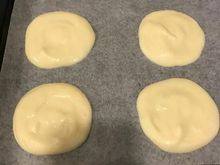 9、韩式—草莓蛋糕卷,烤盘上放烘焙纸⋯在烘焙纸上，挤出4个小圆麵糊⋯挤的时候，由中心往外画，不要太薄哦，尽量挤均匀。