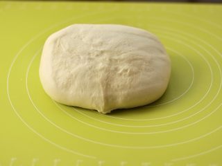 6、甜甜圈,将面团倒扣在揉面垫上